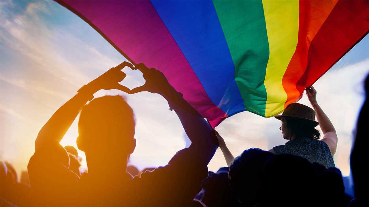 People Waving LGBTQ+ Flag